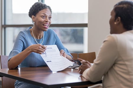 credit union member signing loan application