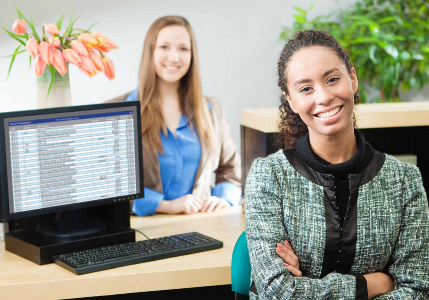 Two Women smiling, looking at the camera