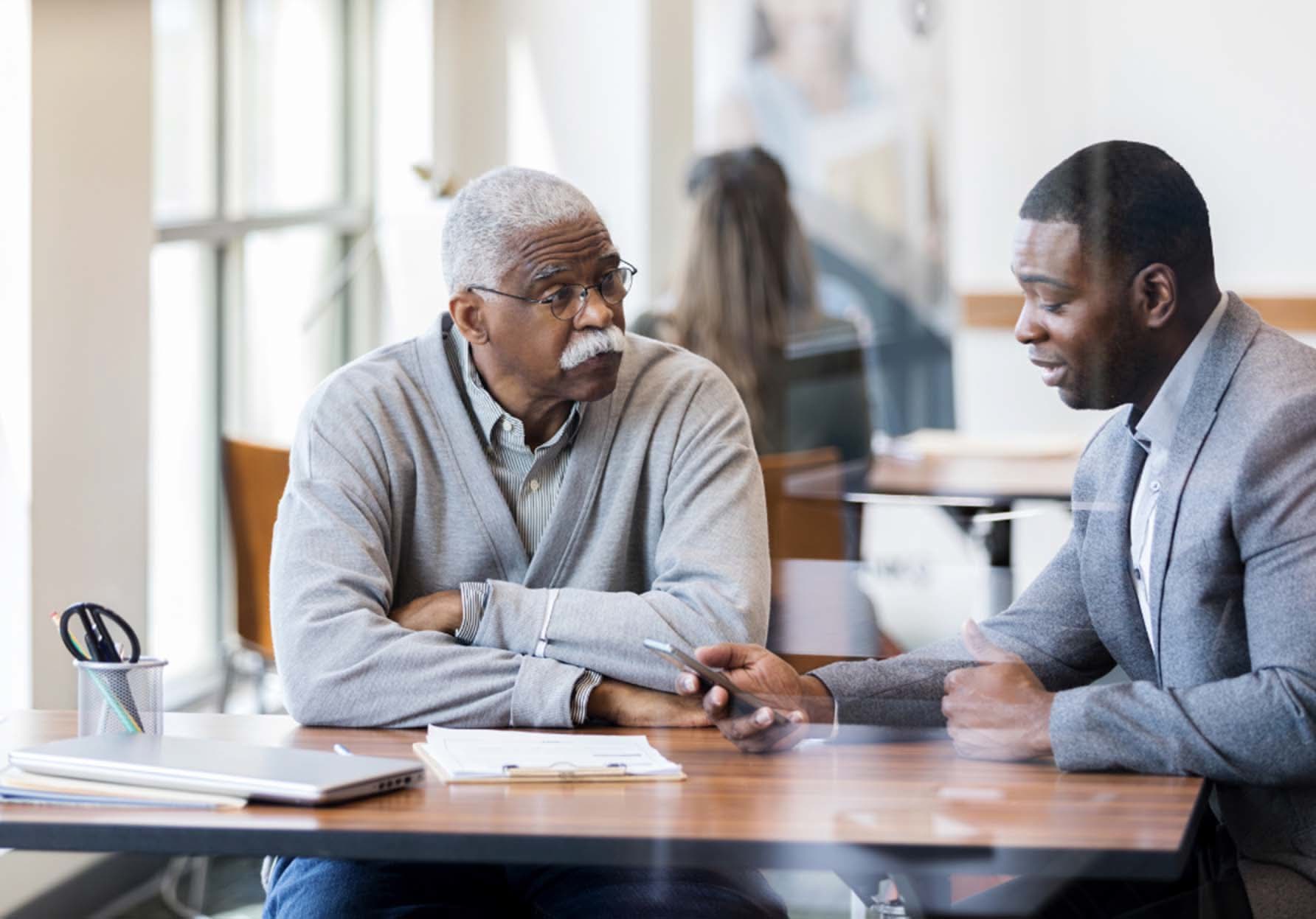 member reviewing savings plan with bankerd